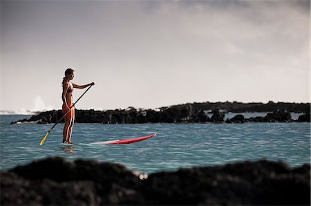 simsearch:614-08868513,k - Surfer paddling surfboard in ocean Photographie de stock - Premium Libres de Droits, Code: 614-08868506