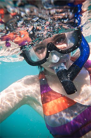 swimsuit underwater posing - Woman wearing snorkel in ocean Stock Photo - Premium Royalty-Free, Code: 614-08868500