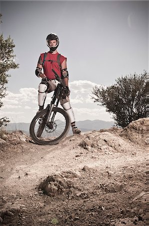 Mountain biker standing on rocky path Stock Photo - Premium Royalty-Free, Code: 614-08868544