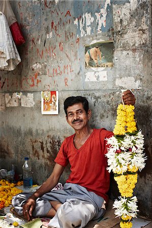 proud man sitting - Man selling garlands on city street Stock Photo - Premium Royalty-Free, Code: 614-08868557