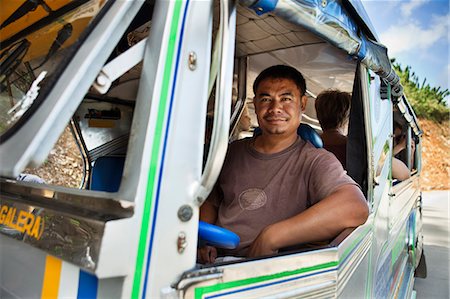 Bus driver smiling at window Stock Photo - Premium Royalty-Free, Code: 614-08868637