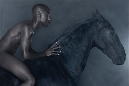 simsearch:6118-08882925,k - Nude man riding black horse Stock Photo - Premium Royalty-Free, Code: 614-08869001