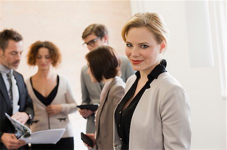 simsearch:6122-08229635,k - Businesswoman smiling in office Stock Photo - Premium Royalty-Free, Code: 614-08869085