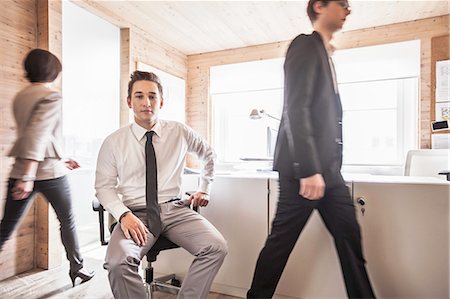 simsearch:614-08866586,k - Businessman sitting in busy office Stock Photo - Premium Royalty-Free, Code: 614-08869351