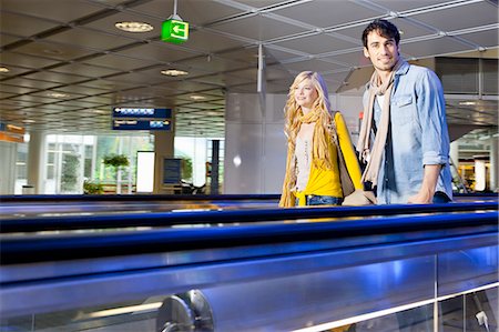 simsearch:400-04354197,k - Couple on moving walkway in airport Stock Photo - Premium Royalty-Free, Code: 614-08869428