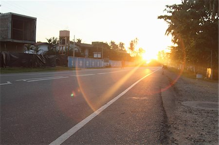 sunset in the streets - Sun shining on rural road Stock Photo - Premium Royalty-Free, Code: 614-08869465