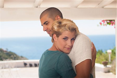 simsearch:614-08866253,k - Smiling couple hugging on balcony Stock Photo - Premium Royalty-Free, Code: 614-08869565