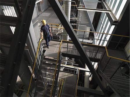 factory stairway interior - Worker climbing staircase in factory Stock Photo - Premium Royalty-Free, Code: 614-08869592