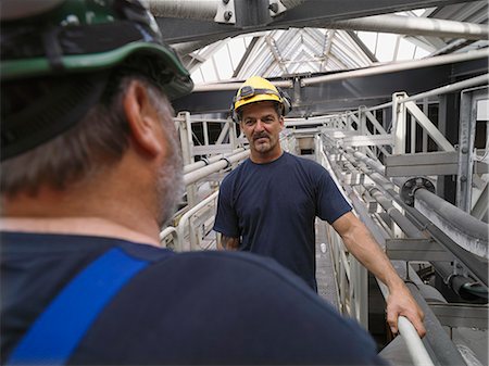 electrical power - Workers talking in factory Stock Photo - Premium Royalty-Free, Code: 614-08869602