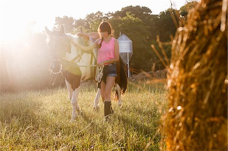 simsearch:400-05342352,k - Woman walking horse in meadow Stock Photo - Premium Royalty-Free, Code: 614-08869630
