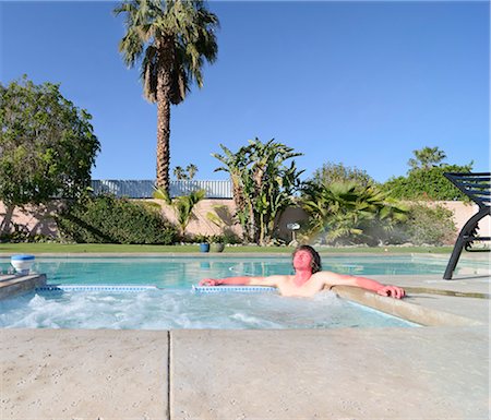 Sunburned man relaxing in hot tub Stock Photo - Premium Royalty-Free, Code: 614-08869864