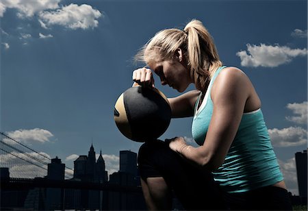 fit woman looking out - Woman resting with ball Stock Photo - Premium Royalty-Free, Code: 614-08874131