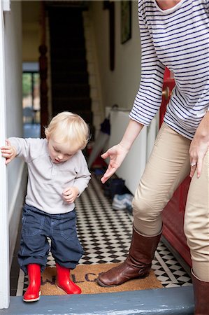 sweater mom - Boy and mother stepping onto doorstep Stock Photo - Premium Royalty-Free, Code: 614-08874263