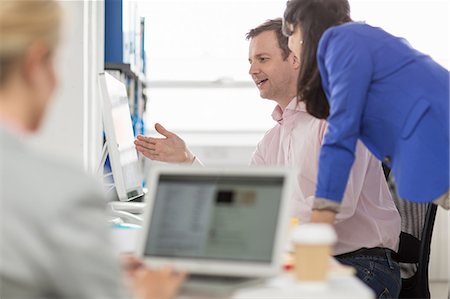 Business colleagues looking at computer monitor in office Stock Photo - Premium Royalty-Free, Code: 614-08874904