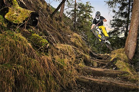 simsearch:649-07560126,k - Male mountain biker riding down forest steps Stock Photo - Premium Royalty-Free, Code: 614-08874972