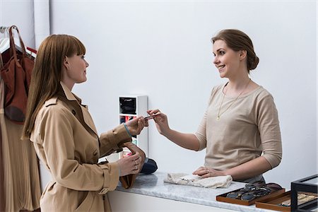 simsearch:6122-07697627,k - Woman making purchase in fashion shop Stock Photo - Premium Royalty-Free, Code: 614-08875017