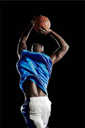 simsearch:6122-07700154,k - Male basketball player jumping with ball Stock Photo - Premium Royalty-Free, Code: 614-08875667