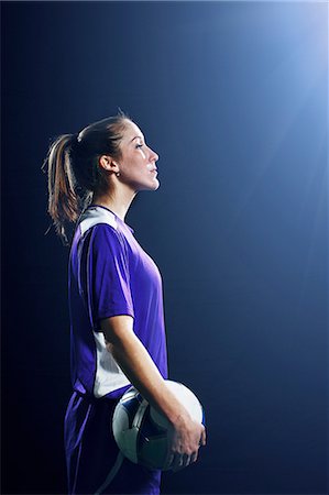 Studio shot of female soccer player holding ball Stock Photo - Premium Royalty-Free, Code: 614-08875695
