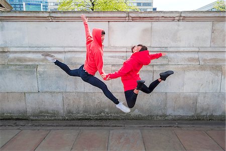 Young male and female dancer mid air in city Stock Photo - Premium Royalty-Free, Code: 614-08875874