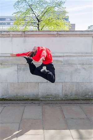 spring fitness - Young male dancer mid air in city Stock Photo - Premium Royalty-Free, Code: 614-08875873