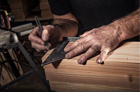 stacking wood - Close up of male carpenter using set square in workshop Stock Photo - Premium Royalty-Free, Code: 614-08876587