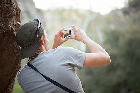 simsearch:614-06895809,k - Young man next to rock taking photograph on digital camera Stock Photo - Premium Royalty-Free, Code: 614-08876607