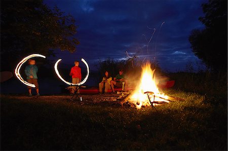 simsearch:614-07145702,k - Family by camp fire, children making light trails in the air Stock Photo - Premium Royalty-Free, Code: 614-08877192