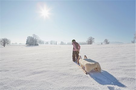 simsearch:649-07804678,k - Young boy pulling sled, rear view Stock Photo - Premium Royalty-Free, Code: 614-08877202