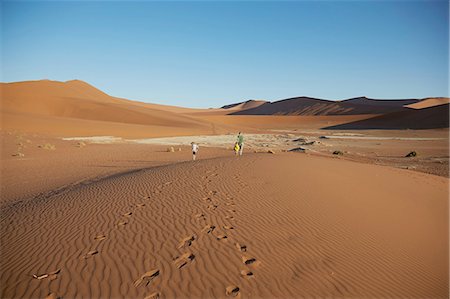 sesriem - Boys walking on sand dune, Namib Naukluft National Park, Namib Desert, Sossusvlei, Dead Vlei, Africa Stock Photo - Premium Royalty-Free, Code: 614-08877457