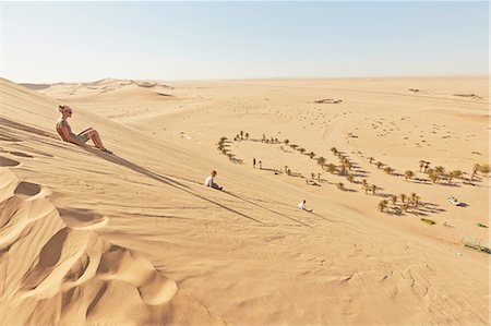 Mother and sons sitting on sand dune, Dune 7, Namib-Naukluft National Park, Africa Stock Photo - Premium Royalty-Free, Code: 614-08877452