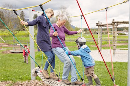 playground and parents - Three generation family playing on rope bridge Stock Photo - Premium Royalty-Free, Code: 614-08877568