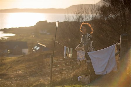 simsearch:614-08877427,k - Woman hanging out washing in garden, Tokavaig, Isle of Skye, Scotland Stock Photo - Premium Royalty-Free, Code: 614-08877562