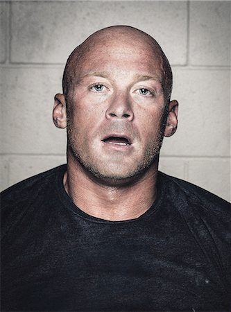 Portrait of bald young man with open mouth after crossfit training Stock Photo - Premium Royalty-Free, Code: 614-08877636