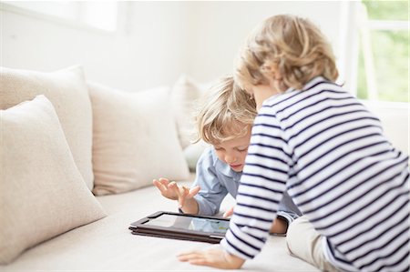 simsearch:649-09208789,k - Two boys sitting on sofa using digital tablet Stock Photo - Premium Royalty-Free, Code: 614-08877783