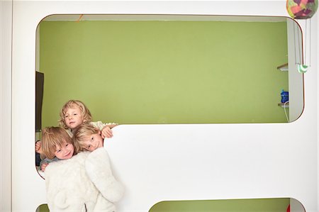 simsearch:649-09208789,k - Three boys together on the top bunk of bunk beds, head and shoulders Stock Photo - Premium Royalty-Free, Code: 614-08877794