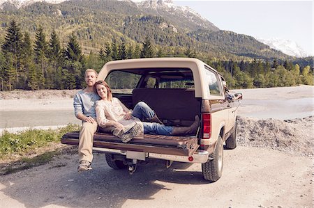 simsearch:614-08879121,k - Couple sitting on back of pick up truck, looking at camera, Wallgau, Bavaria, Germany Stock Photo - Premium Royalty-Free, Code: 614-08877816