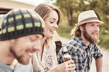 simsearch:614-08877825,k - Three people holding bottled beer smiling Stock Photo - Premium Royalty-Free, Code: 614-08877820