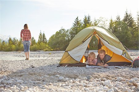 simsearch:614-07031801,k - Family lying on fronts side by side in unzipped tent, looking at map Stock Photo - Premium Royalty-Free, Code: 614-08877845