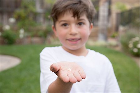 simsearch:614-08877889,k - Portrait of young boy holding tooth in hand, focus on hand Foto de stock - Sin royalties Premium, Código: 614-08877889