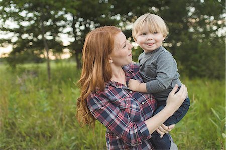 Mother holding young son in field Stock Photo - Premium Royalty-Free, Code: 614-08878498