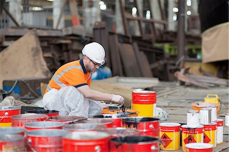 Worker mixing paints in shipyard Stock Photo - Premium Royalty-Free, Code: 614-08878516