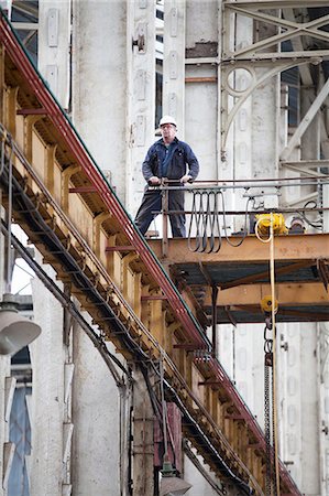 Worker on gantry in shipyard workshop Stock Photo - Premium Royalty-Free, Code: 614-08878532