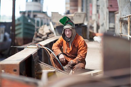 Portrait of welder in shipyard workshop Stock Photo - Premium Royalty-Free, Code: 614-08878546