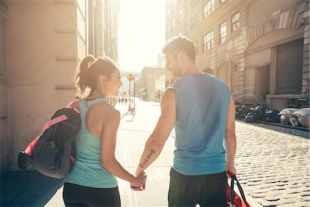 returns - Young couple on street returning from training Stock Photo - Premium Royalty-Free, Code: 614-08878666