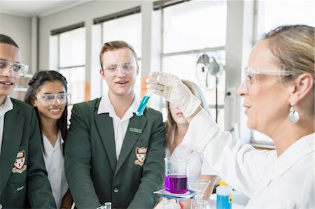 Teacher showing experiment to students in lab Stock Photo - Premium Royalty-Free, Code: 614-08878746