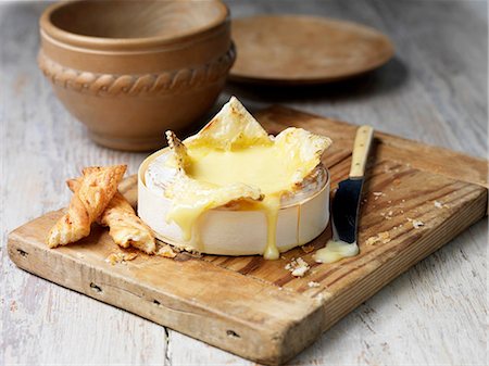 French baking camembert melted with bread sticks on wooden chopping board Photographie de stock - Premium Libres de Droits, Code: 614-08878809