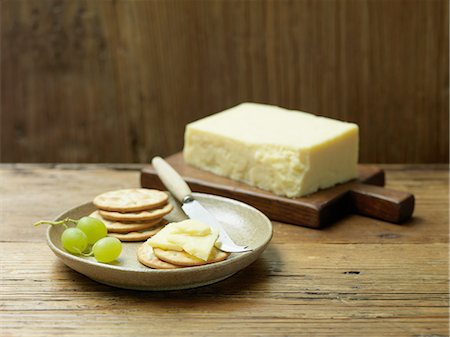 simsearch:614-08879051,k - Mature cheddar cheese with water biscuits and grapes on wood Foto de stock - Sin royalties Premium, Código: 614-08878813