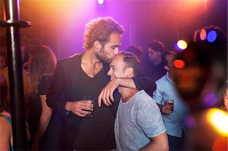 simsearch:649-09209314,k - Young man kissing friend's head in club Stock Photo - Premium Royalty-Free, Code: 614-08878921