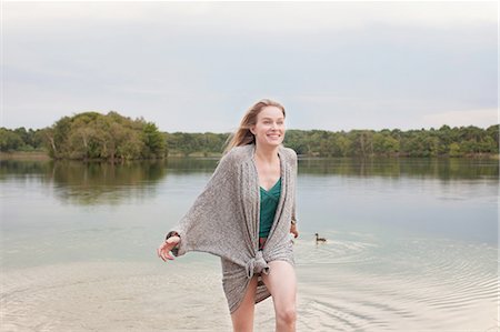 people the netherlands - Young woman playing in lake Stock Photo - Premium Royalty-Free, Code: 614-08878991