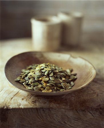 simsearch:614-08879057,k - Organic pumpkin seeds in wooden bowl Stock Photo - Premium Royalty-Free, Code: 614-08879058